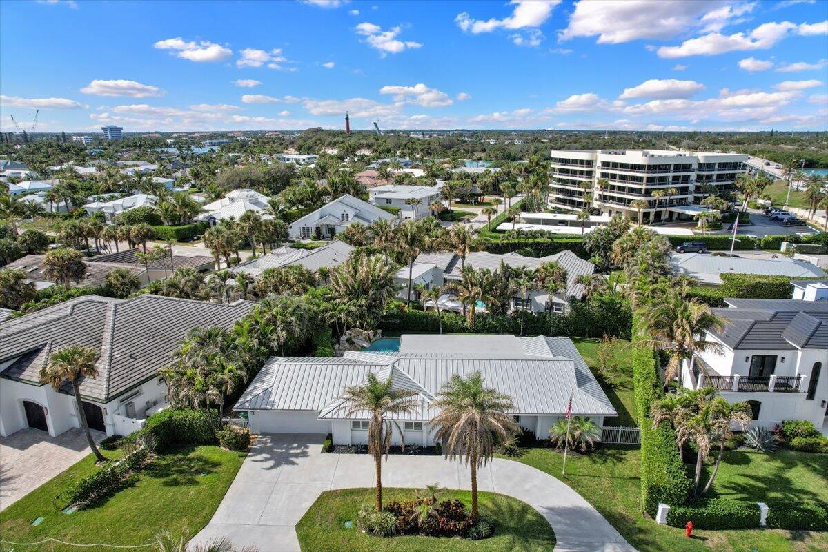 An aerial view of a single-story house with a metal roof and a circular driveway — 48 Ocean Drive, Jupiter FL 33469, JUPITER, FL