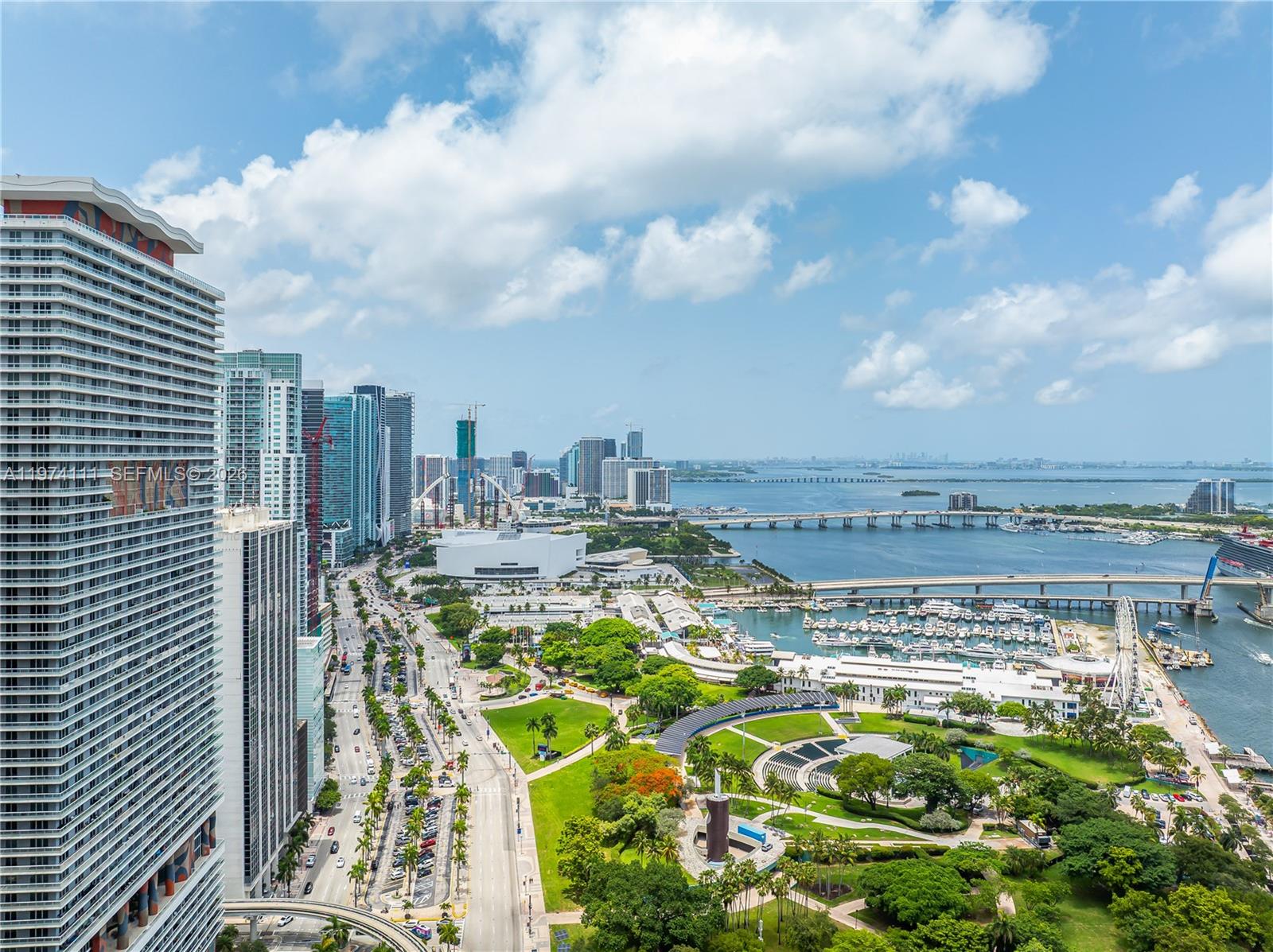 An aerial view of a Miami waterfront park, city skyline, and bridge over the bay — 50 Biscayne Blvd # 3106, Miami FL 33132, MIAMI, FL