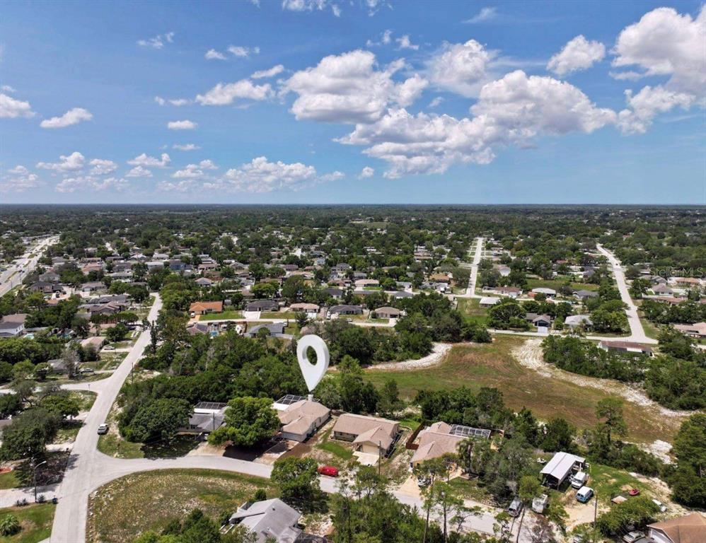 An aerial view shows a residential neighborhood with a house marked by a location pin — 5137 MONTFORD CIRCLE, SPRING HILL, FL