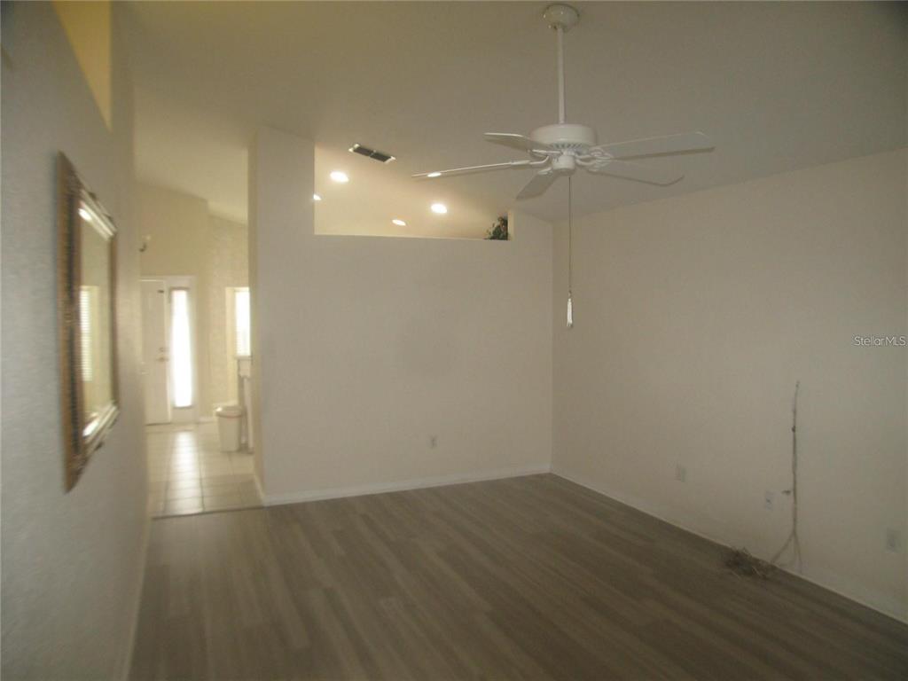 An interior view of a room with wood-look flooring, a ceiling fan, and recessed lighting — 145 CROOKED PINE ROAD, PORT ORANGE, FL
