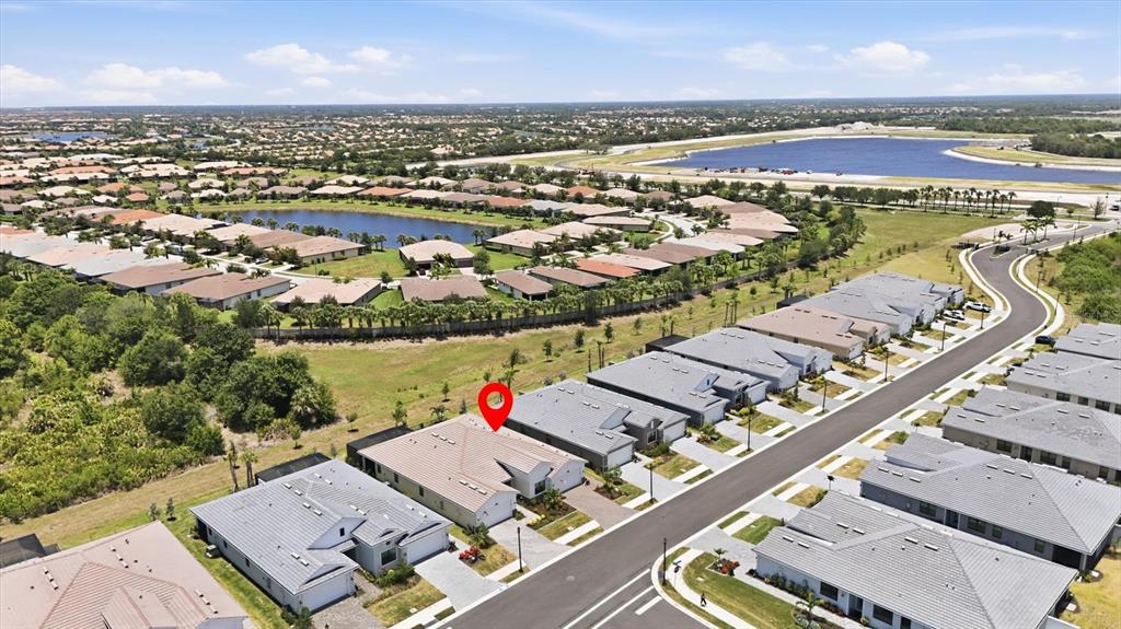 An aerial view shows a residential neighborhood with a red location pin on a house — 18839 DAYSPRING PLACE, VENICE, FL