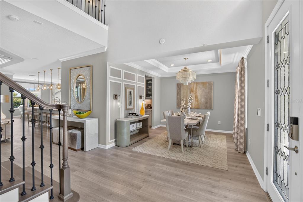 An entryway leads to a dining room with a chandelier, wood floors, and paneling — 8228 SUMMER NIGHT ROAD, SARASOTA, FL