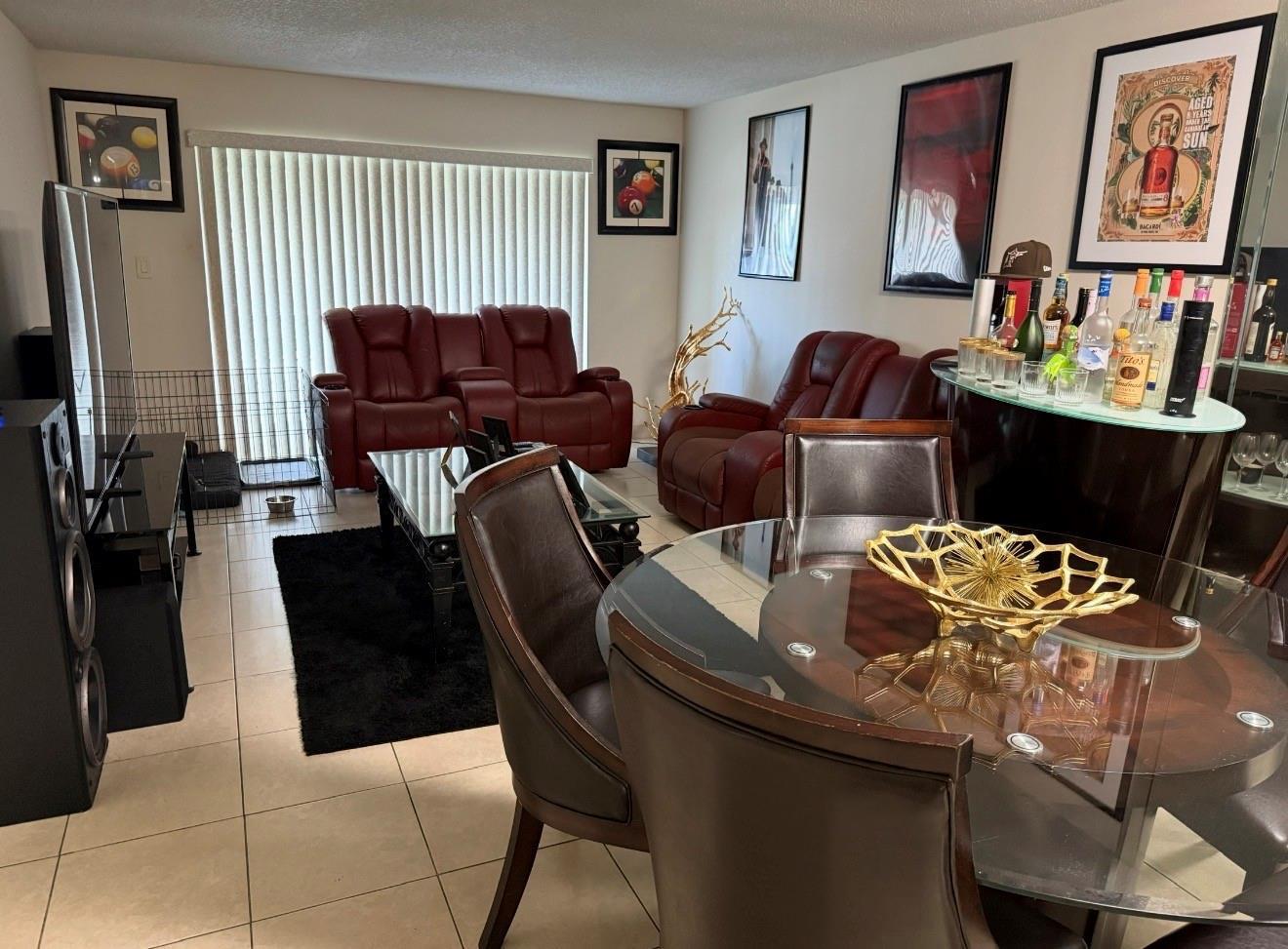 A living and dining area features red leather recliners, a glass-top table, and a home bar — 5515 Lakewood Circle # 125, Pompano Beach FL 33063, POMPANO BEACH, FL