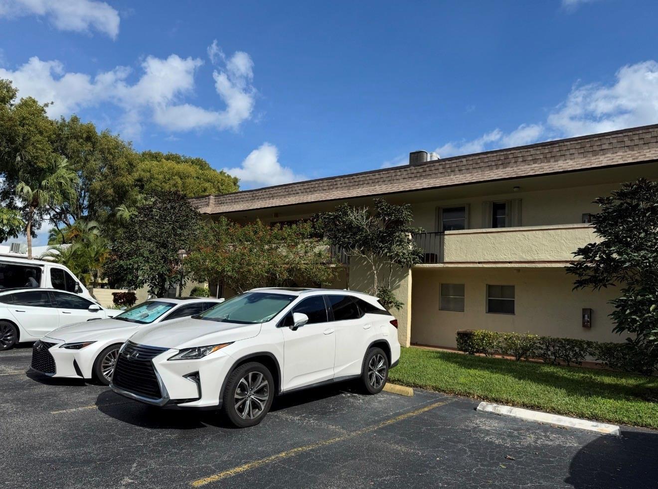 A white Lexus SUV is parked in front of a two-story apartment building — 5515 Lakewood Circle # 125, Pompano Beach FL 33063, POMPANO BEACH, FL