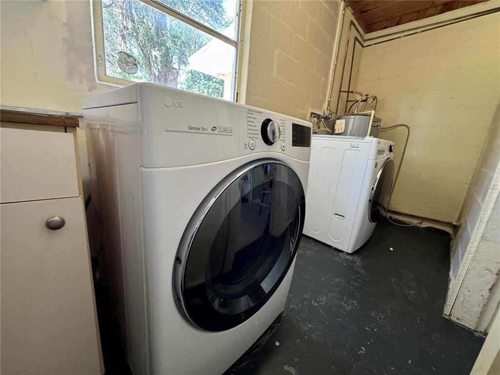 A laundry room features a white LG dryer and a matching washing machine on a floor — 310 LONGWOOD DRIVE, BROOKSVILLE, FL