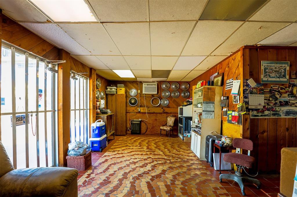 A commercial office space features wood-paneled walls, a patterned tile floor, and a drop ceiling — 133 W STUART AVENUE, LAKE WALES, FL