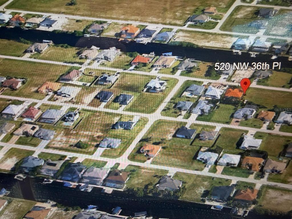 This is an aerial map view of a residential neighborhood with houses and canals — 4520 NW 36TH AVENUE, CAPE CORAL, FL