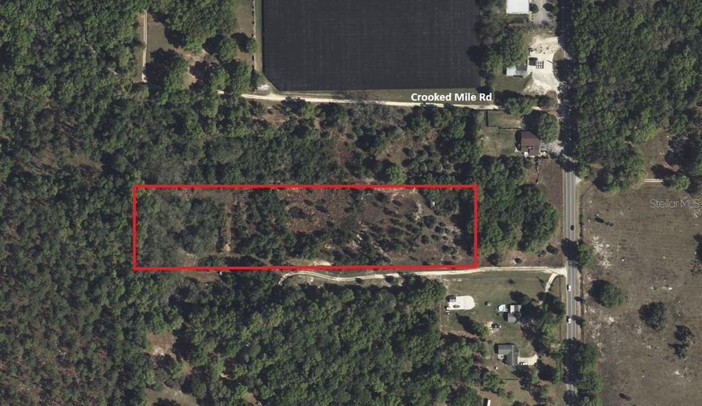 An aerial view shows a rectangular plot of land outlined in red near a road — 00 Crooked Mile ROAD, PAISLEY, FL