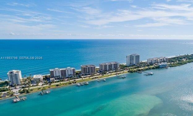 An aerial view shows several high-rise residential buildings situated on a narrow coastal strip — 19670 Beach Rd # A601, Tequesta FL 33469, TEQUESTA, FL