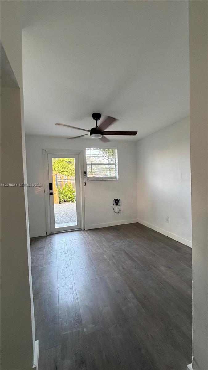 A room with gray wood-look flooring, a ceiling fan, and a glass-paneled exterior door — 7025 NW 5th Ave # 2, Miami FL 33150, MIAMI, FL