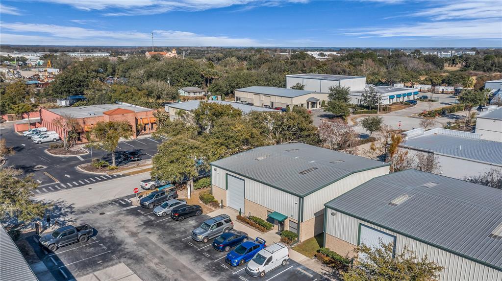 An aerial view shows several industrial warehouse buildings with metal roofs and adjacent parking lots — 333 GORDON STREET, SANFORD, FL