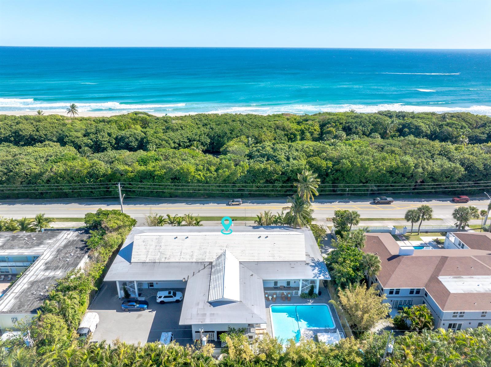 An aerial view shows a coastal property with a swimming pool near the ocean — 501 N Ocean Boulevard, Boca Raton FL 33432, BOCA RATON, FL