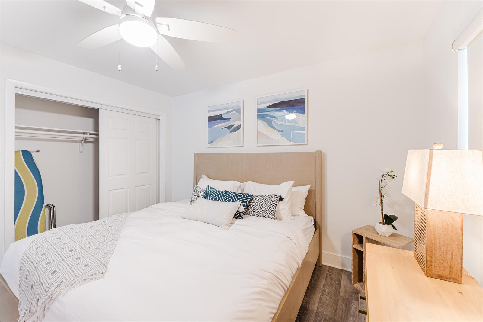A bedroom features a bed with white bedding, a ceiling fan, and a wooden nightstand — 501 N Ocean Boulevard, Boca Raton FL 33432, BOCA RATON, FL