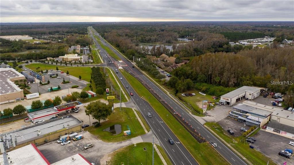 An aerial view shows a multi-lane highway running through a commercial and wooded area — 1635 DALE MABRY HIGHWAY, LUTZ, FL