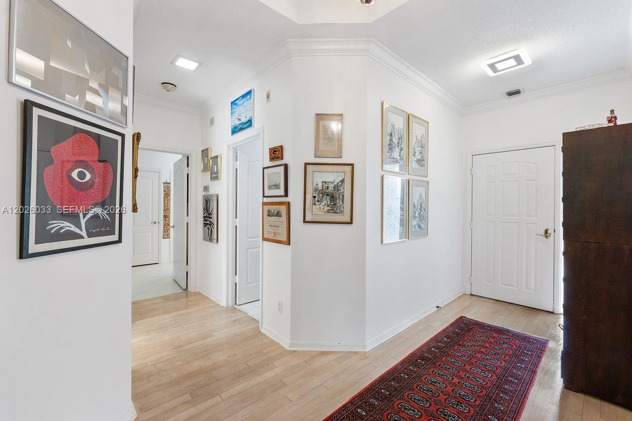 A bright living area features tile flooring, a central column, and a built-in planter — 10411 SE Terrapin Place # 203, Jupiter FL 33469, JUPITER, FL