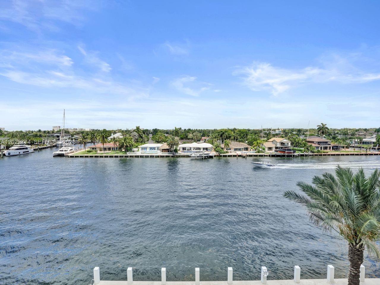 A view of a waterway with boats, docks, and houses along the opposite shore — 407 N Riverside # 402, Pompano Beach FL 33062, POMPANO BEACH, FL