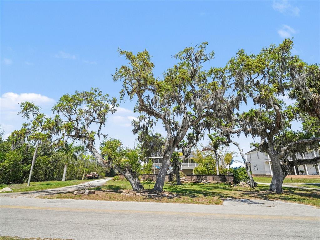 A two-story house with a patio, swimming pool, and shade sail in the backyard — 1740 BAYSHORE DRIVE, TERRA CEIA, FL