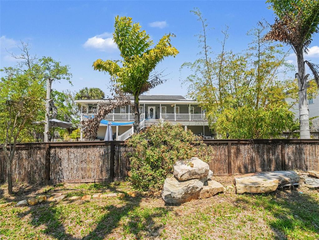 An elevated house with a deck overlooks a swimming pool and a stone patio — 1740 BAYSHORE DRIVE, TERRA CEIA, FL