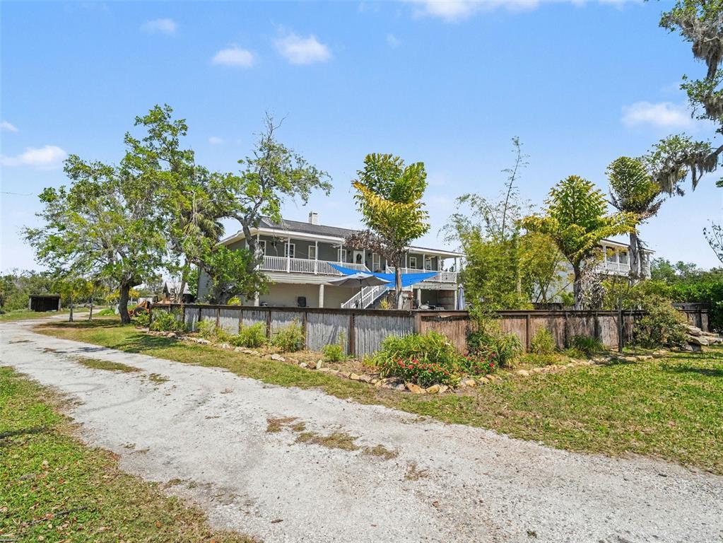 A backyard swimming pool and attached spa with a blue shade sail and patio area — 1740 BAYSHORE DRIVE, TERRA CEIA, FL