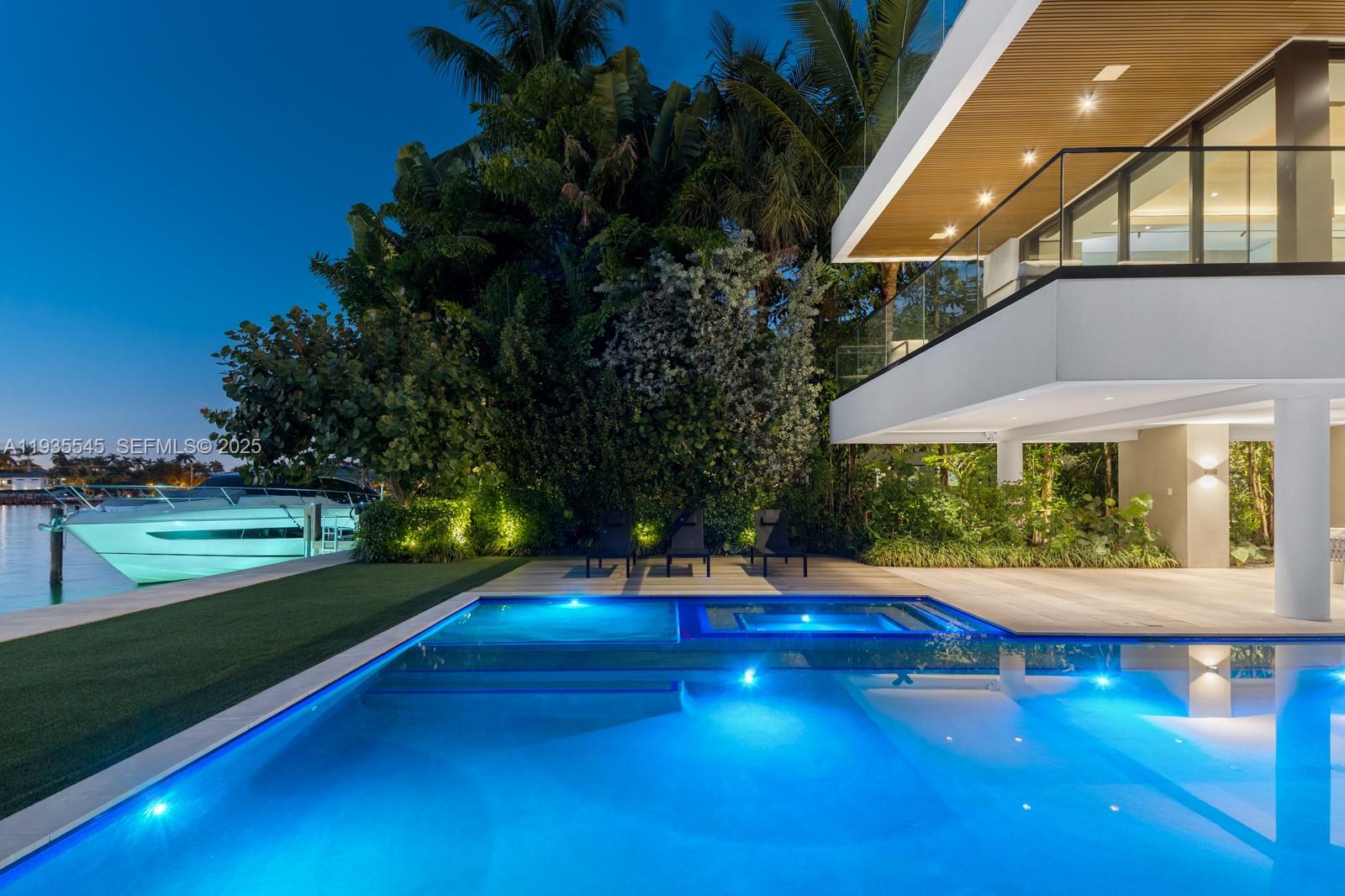 A modern house with a pool, spa, and boat dock at night — 40 W Rivo Alto Dr, Miami Beach FL 33139, MIAMI BEACH, FL