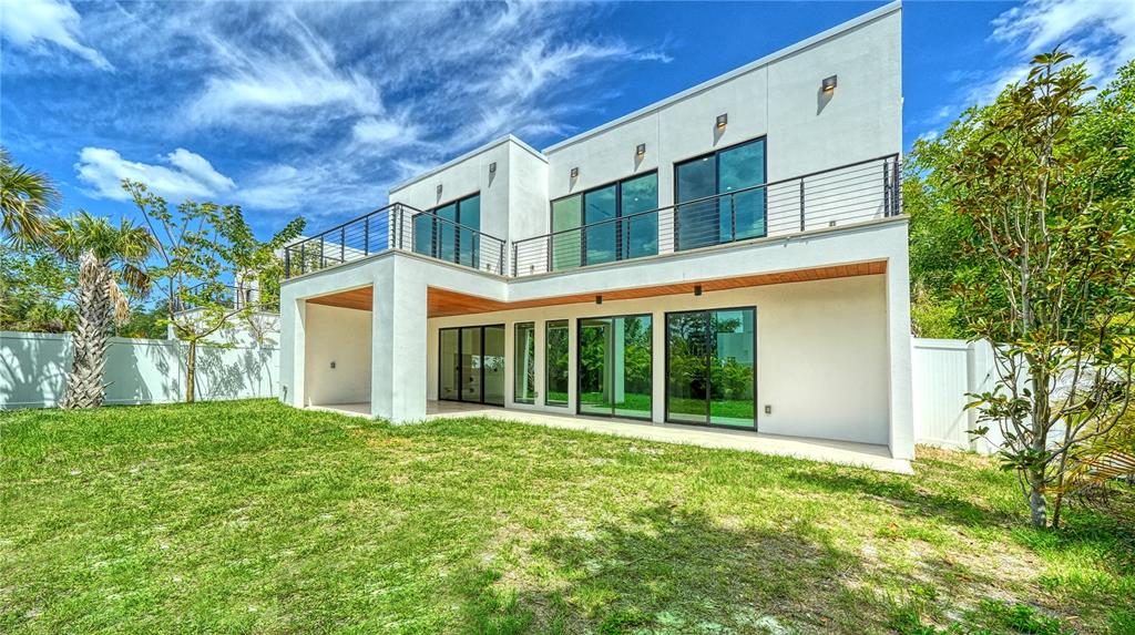 A modern two-story white house with a flat roof, large glass doors, and a balcony — 1734 WISCONSIN LANE, SARASOTA, FL