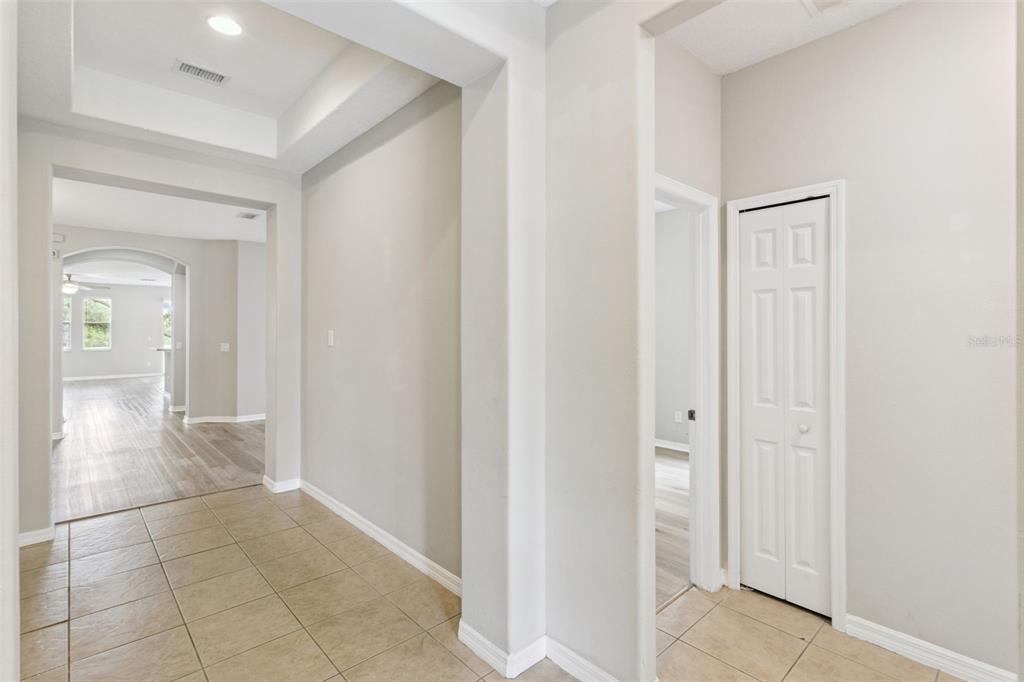 A tiled entryway leads to a hallway with a closet and a view into rooms — 4627 BLUE MAJOR DRIVE, WINDERMERE, FL