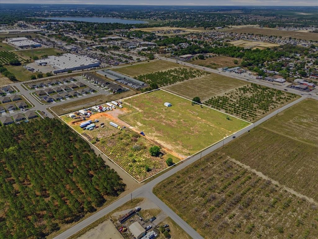 An aerial view shows a large, rectangular vacant lot outlined in white near a road — 186 LEWIS GRIFFIN ROAD, LAKE WALES, FL