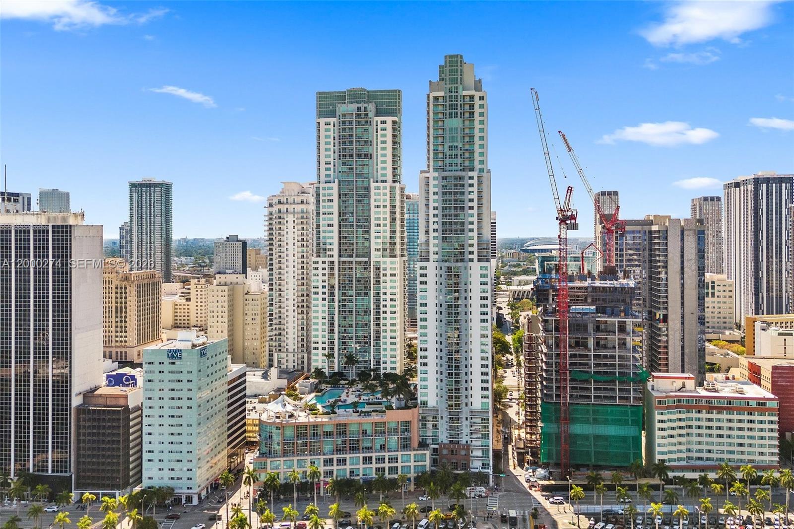 An aerial view of a dense urban skyline featuring several high-rise buildings and construction cranes — 244 Biscayne Blvd # 1709, Miami FL 33132, MIAMI, FL