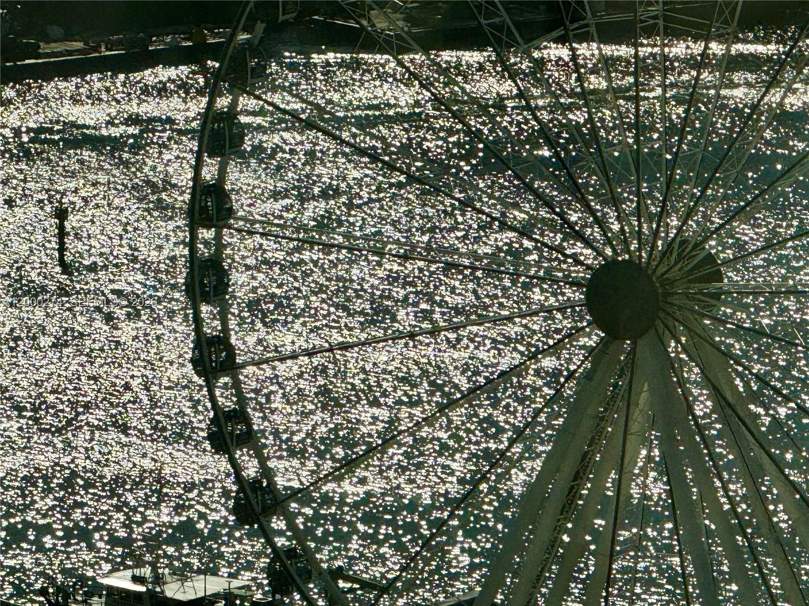 A large Ferris wheel stands against a background of sparkling water — 244 Biscayne Blvd # 1709, Miami FL 33132, MIAMI, FL