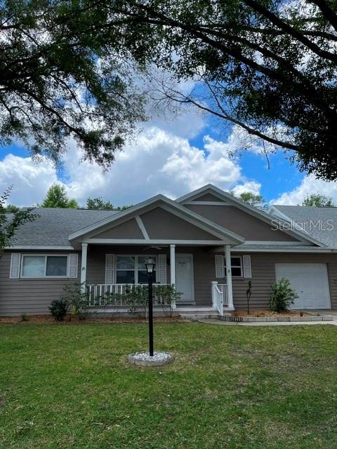A single-story house with a covered front porch and a white garage door — 8540 SW 91ST PLACE UNIT C, OCALA, FL