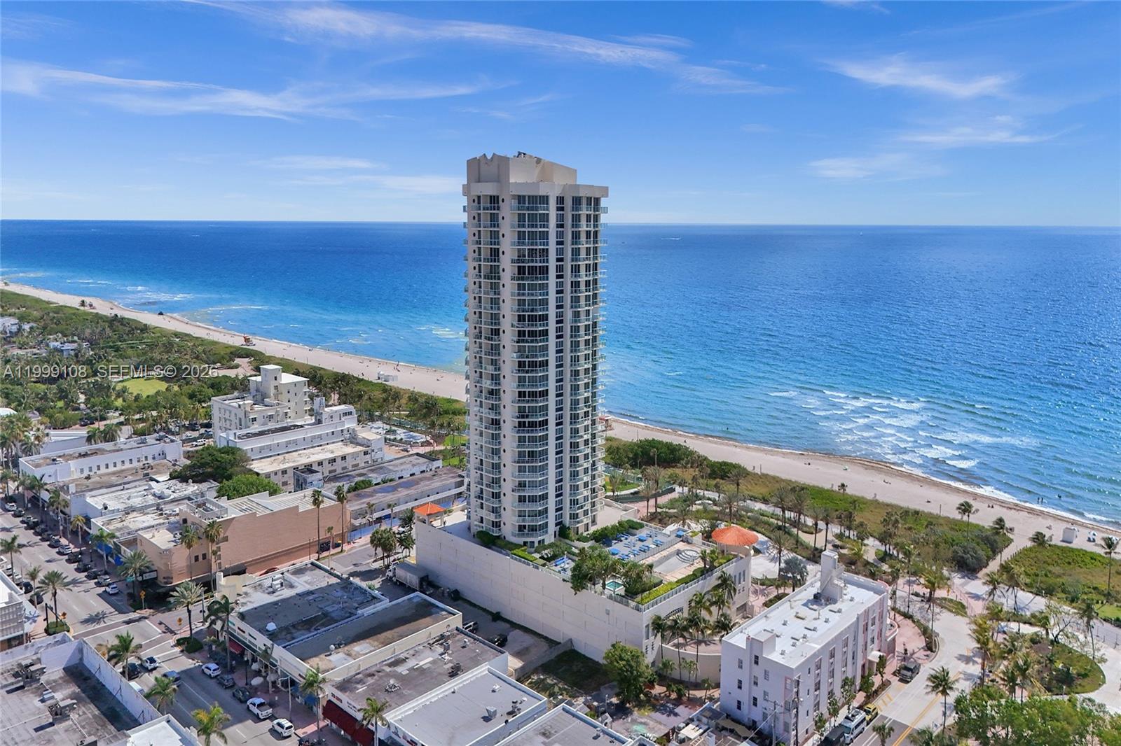 An aerial view shows a tall residential tower situated on a beach near the ocean — 7330 Ocean Ter # C, Miami Beach FL 33141, MIAMI BEACH, FL