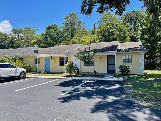 A one-story apartment building with yellow siding and a white car parked in front — 2780 PARK DRIVE UNIT C-3, CLEARWATER, FL
