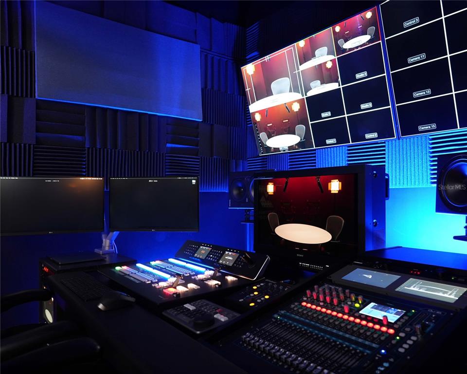 A professional media control room features multiple monitors, a mixing console, and acoustic wall panels — 4705 S APOPKA VINELAND ROAD UNIT 210, ORLANDO, FL