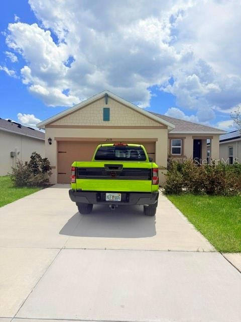 A bright green pickup truck is parked in the driveway of a suburban house — 2579 SAGE VALLEY WAY, WINTER HAVEN, FL