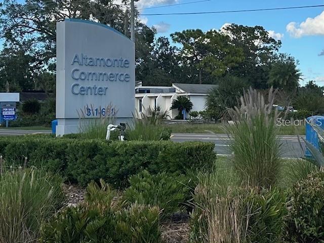 A sign for the Altamonte Commerce Center stands in front of a commercial building — 251 ALTAMONTE COMMERCE BOULEVARD UNIT 1402, ALTAMONTE SPRINGS, FL