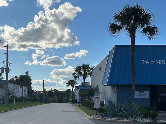 A street view shows a commercial building with a blue roof and a palm tree — 251 ALTAMONTE COMMERCE BOULEVARD UNIT 1402, ALTAMONTE SPRINGS, FL