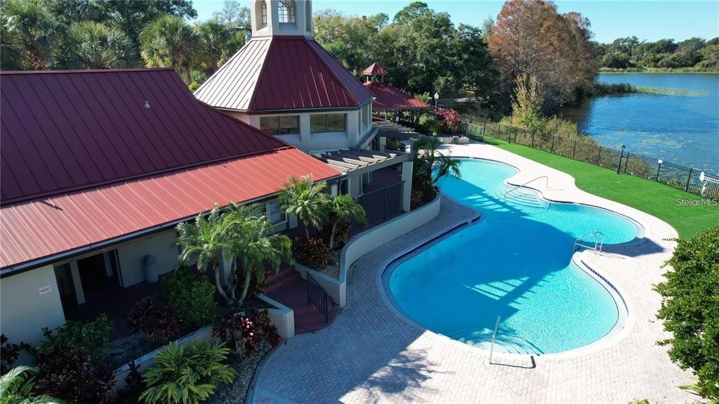 An aerial view shows a building with a red metal roof beside a swimming pool — 199 AFTON SQUARE UNIT 309, ALTAMONTE SPRINGS, FL