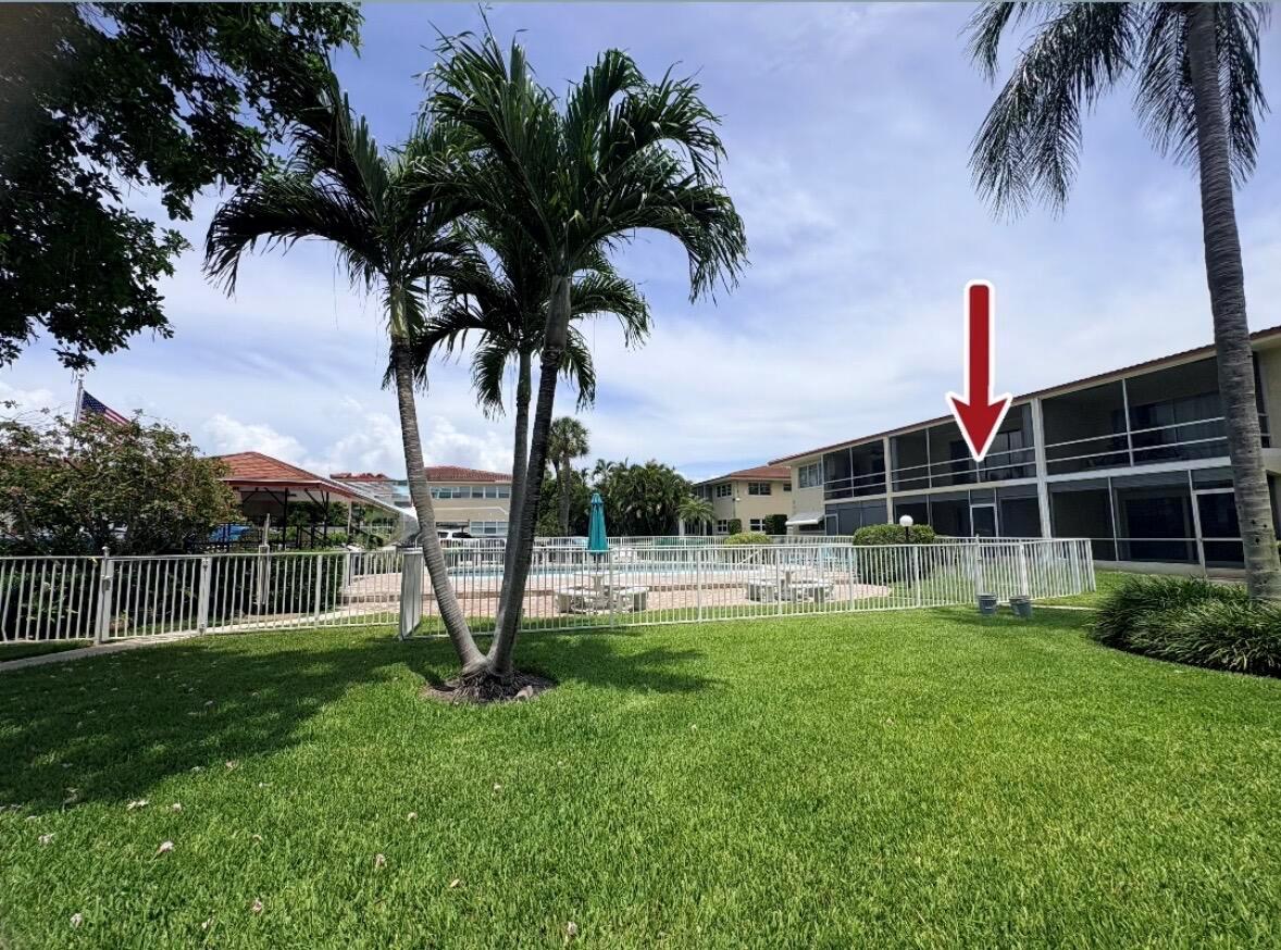 Exterior view of a multi-story apartment building with a screened balcony overlooking a swimming pool — 2202 NE 36th Street # 17, Lighthouse Point FL 33064, LIGHTHOUSE POINT, FL