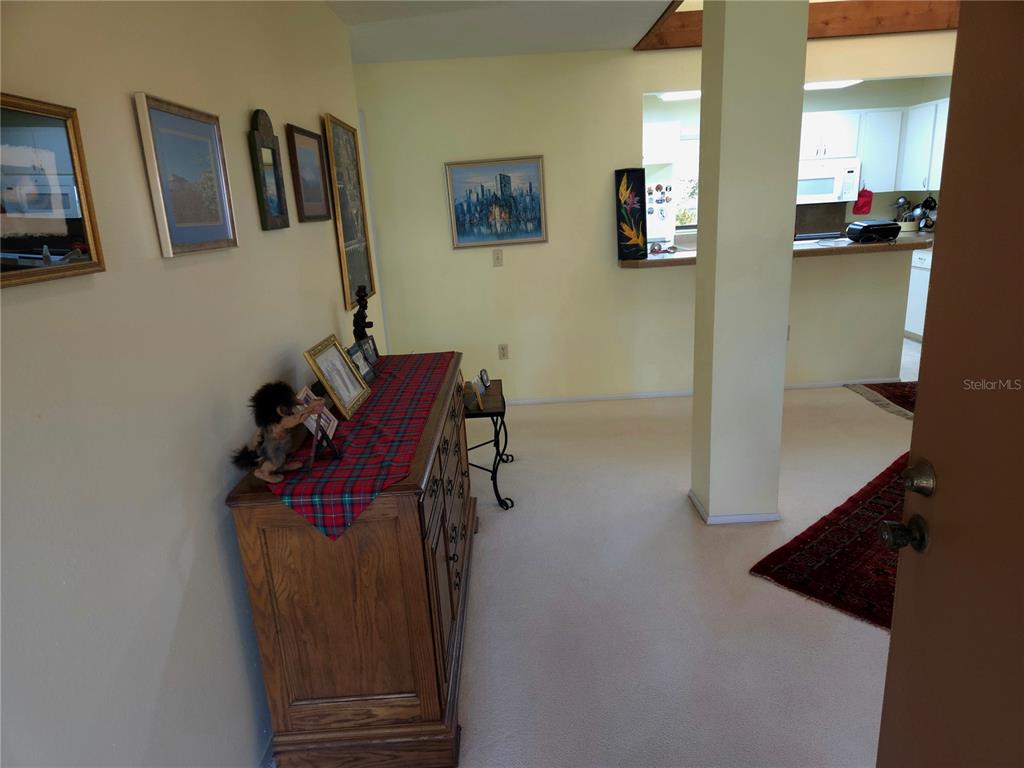 A wooden dresser with a plaid runner sits in a room with light-colored walls — 6402 MEADOWLARK LN, BRADENTON, FL