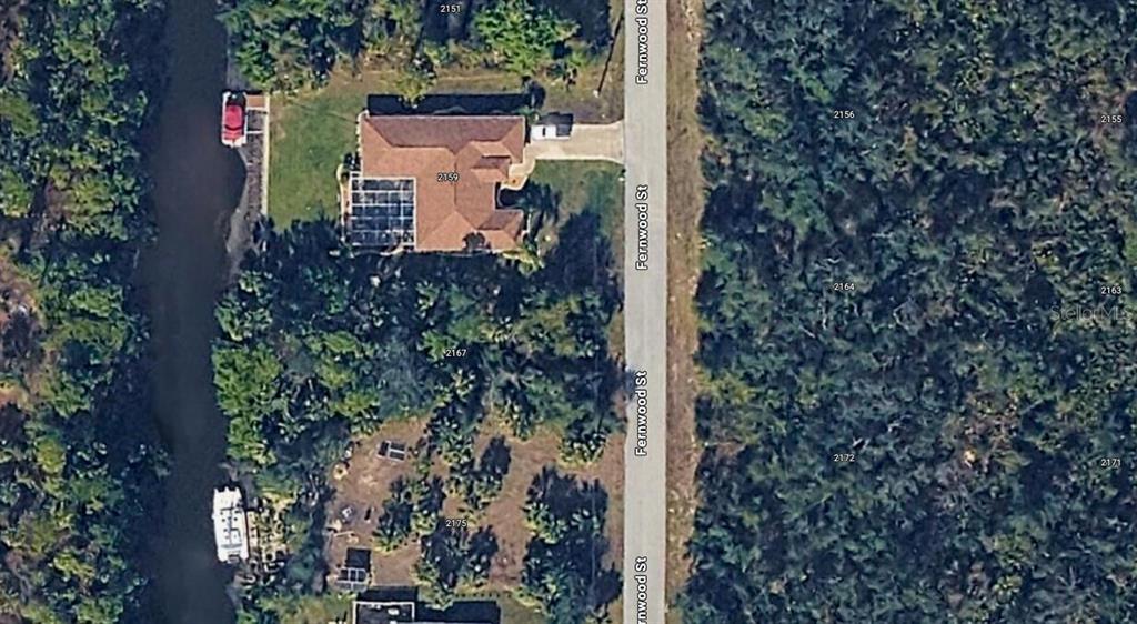 This is an aerial map view showing a house with a pool cage and canal — 2167 FERNWOOD STREET, PORT CHARLOTTE, FL