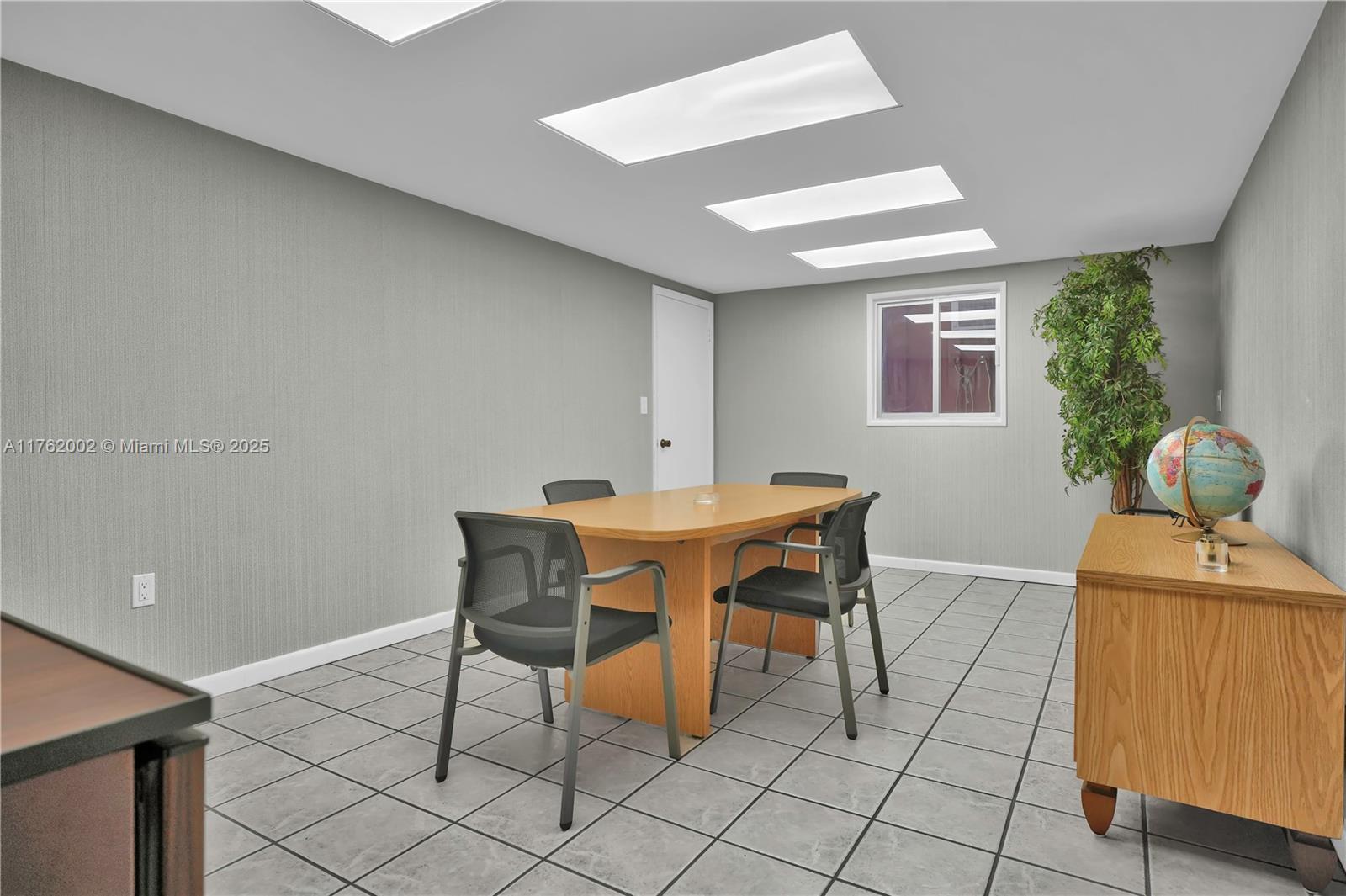 A conference room features gray walls, tiled floors, a wooden table, and recessed ceiling lights — 5220 NW 72nd Ave # A1, Miami FL 33166, MIAMI, FL