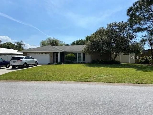 A single-story house with a two-car garage and a large front lawn — 3654 PIN OAKS STREET, SARASOTA, FL