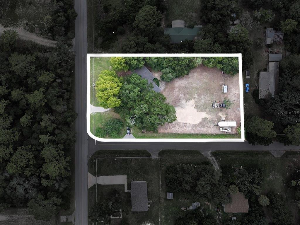 An aerial view shows a residential lot with a house, trees, and a large yard — 11025 SE 132ND PLACE, OCKLAWAHA, FL