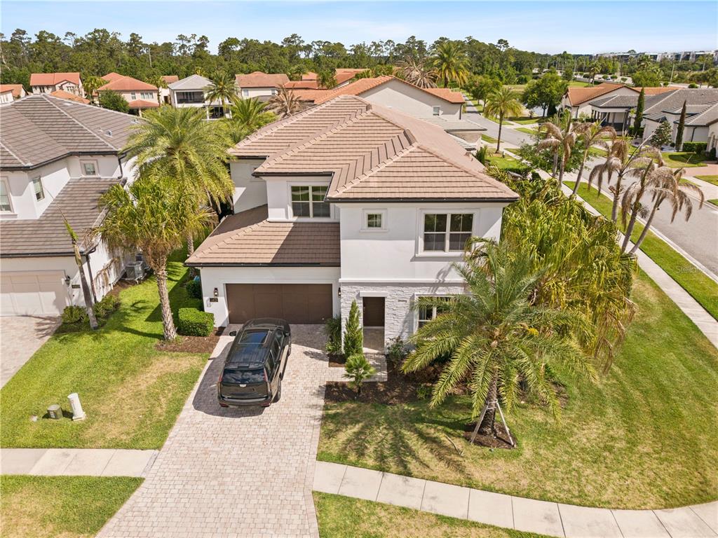 An aerial view of a two-story suburban house with a tiled roof and paved driveway — 10829 ROYAL CYPRESS WAY, ORLANDO, FL