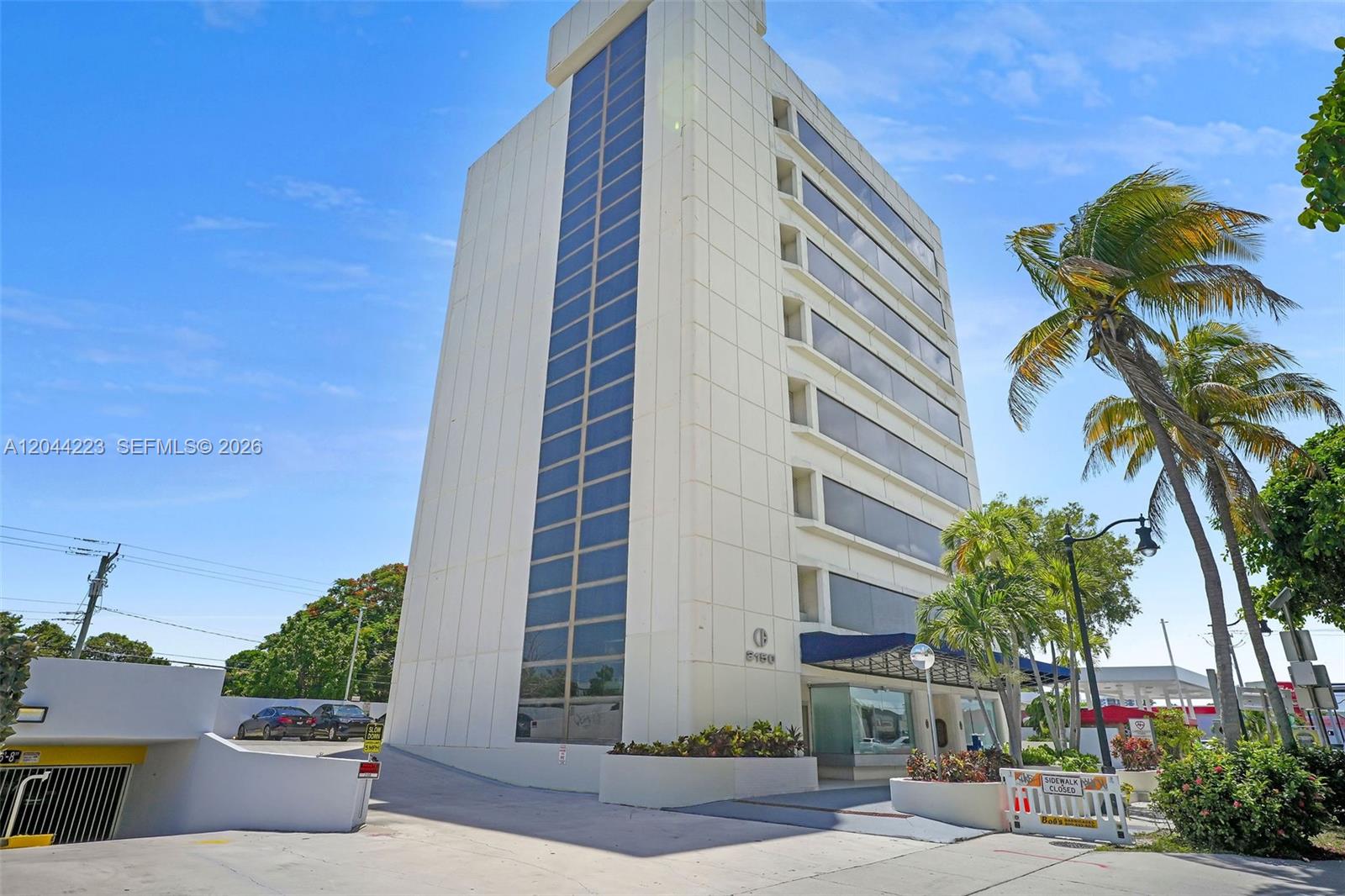 A multi-story office building with a glass facade and a blue awning over the entrance — 2150 SW 22nd St # 7A, Miami FL 33145, MIAMI, FL