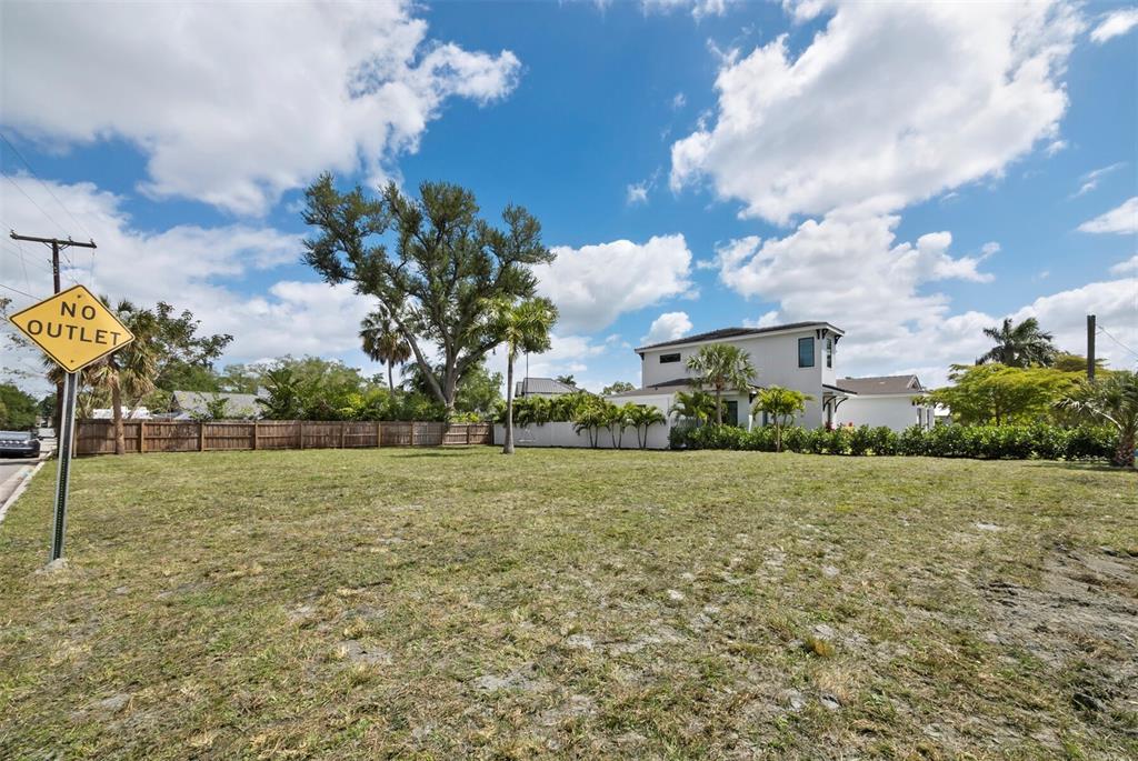A vacant grassy lot features a no outlet sign and a neighboring two-story house — 1703 ALTA VISTA STREET, SARASOTA, FL