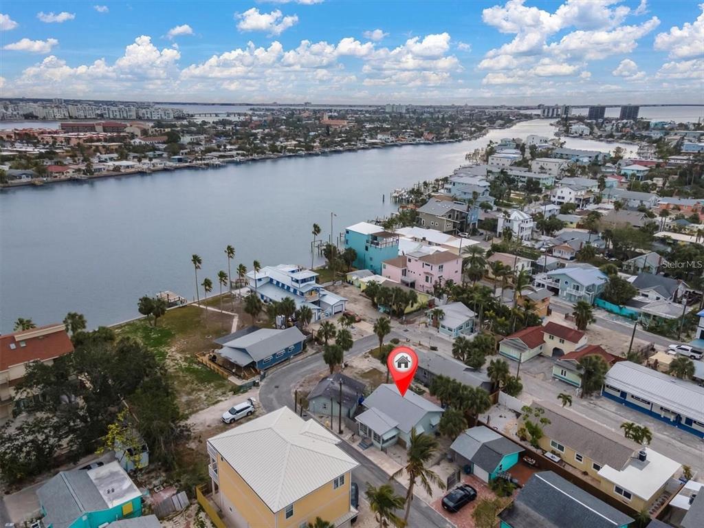 An aerial view shows a coastal neighborhood with a house marked by a location pin — 137 91ST AVENUE, TREASURE ISLAND, FL