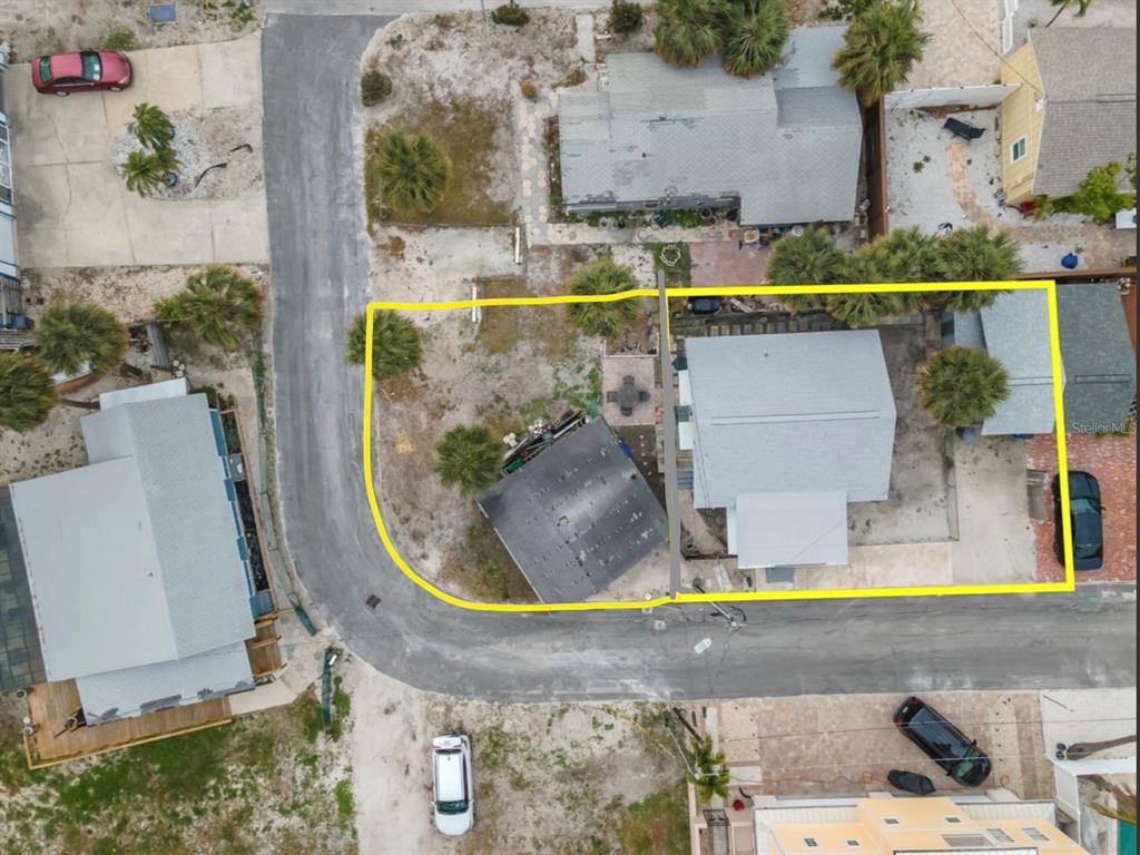 Aerial view of two adjacent residential lots outlined in yellow on a paved street — 137 91ST AVENUE, TREASURE ISLAND, FL