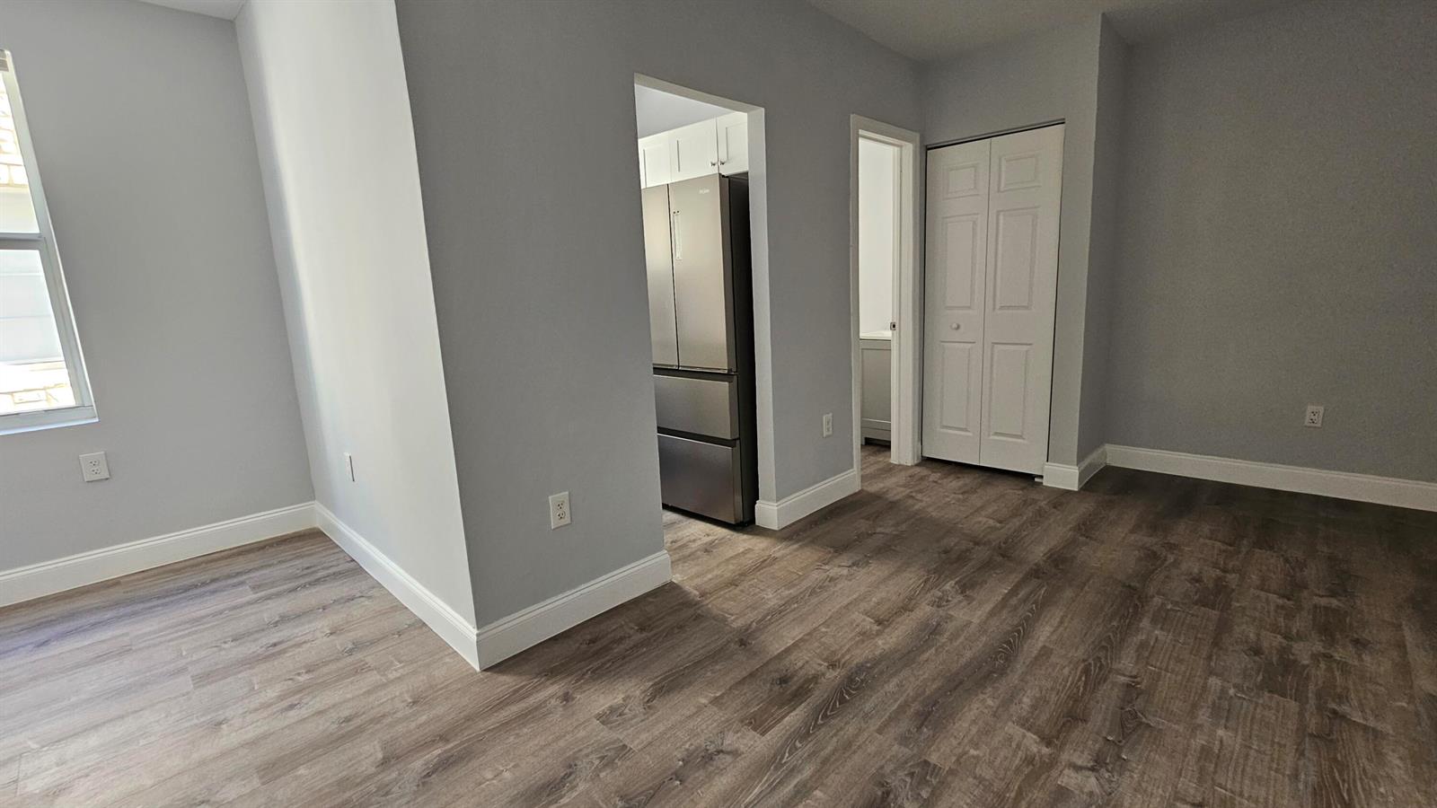 A kitchen area with gray walls, wood-look flooring, three windows, and a ceiling fan — 1142 SW 4th Street # 9, Miami FL 33130, MIAMI, FL