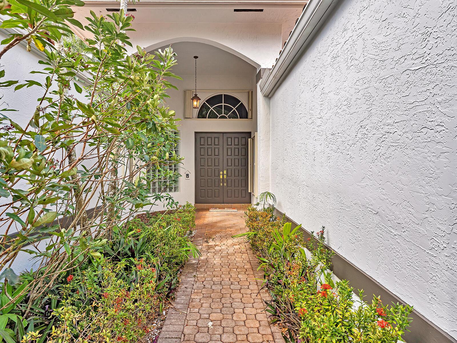 A brick walkway leads to a double front door under a covered entryway — 3420 Washington Lane, Cooper City FL 33026, COOPER CITY, FL
